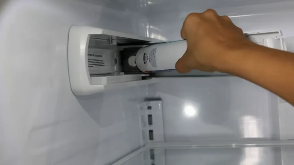 How do I reset my GE refrigerator ice maker?